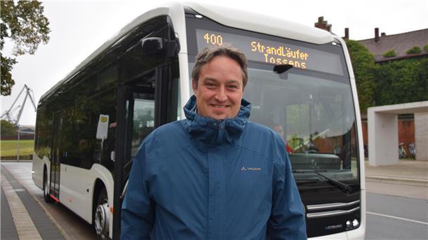 Mann vor Bus