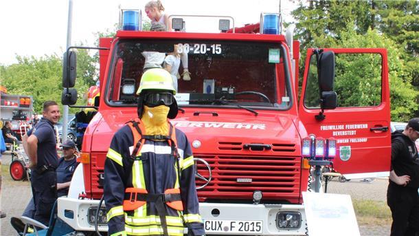 Feuerwehr Wehdel feiert: Kommers, Ehrungen und spannende Übungen Kinder und Feuerwehrleute tummeln sich um ein Tanklöschfahrzeug.