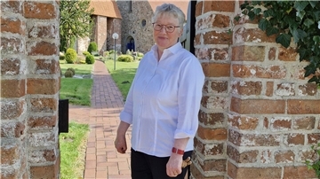 Christa Maschke vor der schönen Kirche in Debstedt.