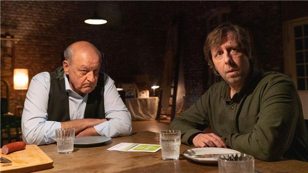 Wilsberg (Leonard Lansink, l) ist sich nicht sicher, ob er den Auftrag über Ermittlungen im Veterinäramt annehmen soll, Ekki (Oliver Korittke, r) hat weniger Bedenken. in einer Szene aus „Wilsberg - Schmeckt nach Mord“ (undatiert). Der Krimi wird am 01.10.2022 im ZDF ausgestrahlt.