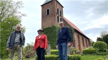 Wolfgang Martens, Claudia Peplau und Ernst Heinje stehen vor der Kirche.