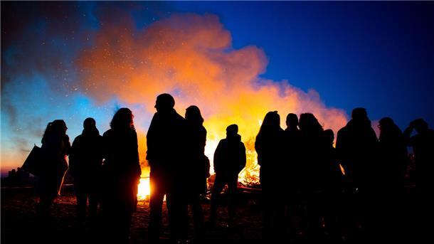 Brauchtum rund um Zeven: Hier brennen die Osterfeuer in der Region Zahlreiche Menschen stehen an einem Osterfeuer. Auch in der Region Zeven finden an den Feiertagen vielerorts Osterfeuer statt. Das erste Feuer wird bereits an Karfreitag entzündet.