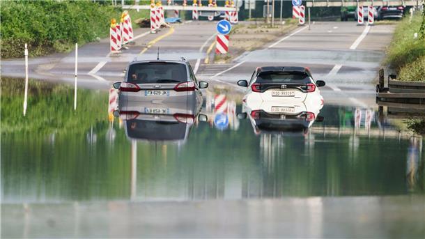 Hochwasser im Südwesten - Aufräumen und abwarten Zwei Autos stehen unter einer Saarbrücke in Saarbrücken im Hochwasser.