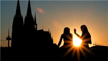 Zwei Frauen vor dem Kölner Dom:  Beim ersten Date verzichten junge Leute nach Tinder-Angaben heutzutage lieber auf Alkohol und treffen sich zu kulturellen Aktivitäten oder draußen statt im Restaurant.